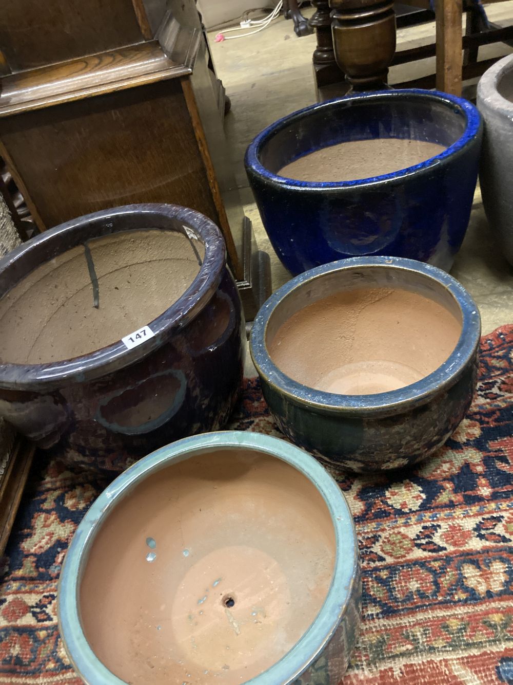 Four glazed earthenware garden planters, largest diameter 37cm